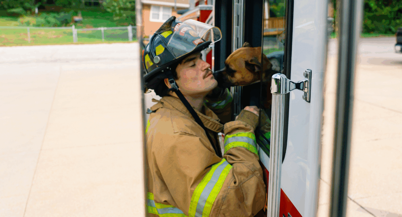Dog licks firefighter through window of fire truck